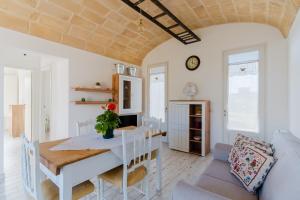 a dining room with a table and a couch at Dimora Balu' in Parabita +19 photos