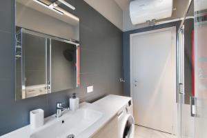 a bathroom with a sink and a mirror at Colico Center in Colico +22 photos