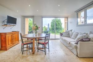 a living room with a table and a couch at Gite Deodatus avec piscine in Cladech