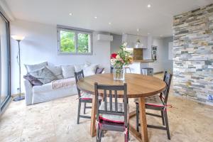 a dining room and living room with a table and chairs at Gite Deodatus avec piscine in Cladech