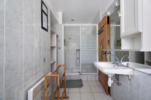 a bathroom with a sink and a shower at Le Fenil gîte avec piscine partagée in Saint-Thual +25 photos
