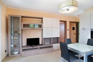 a dining room with a table and a television at Appartamento Vallebona in Seborga