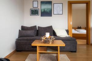 a living room with a couch and a table with a candle at Florianshof in Tesimo