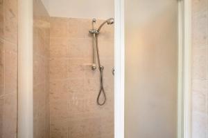 a shower with a shower head in a bathroom at Appartamento Vallebona in Seborga