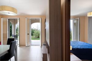 a bedroom with a bed and a table and a dining room at Appartamento Vallebona in Seborga