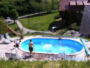 a man standing next to a swimming pool at Vogtadeshof in Wolfach