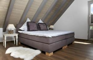 a bed with pillows on it in a room at Atemlos in Ibach +20 photos