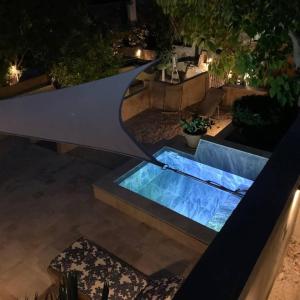 a swimming pool in a backyard at night at Maisonnette indépendante in Cassis +15 photos
