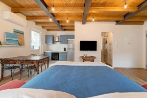a bedroom with a large bed and a dining room at Ca' Vittorio in Rossiglione