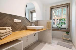 a bathroom with a sink and a mirror at Eichengeflüster Waldhütte in Wagenfeld +22 photos