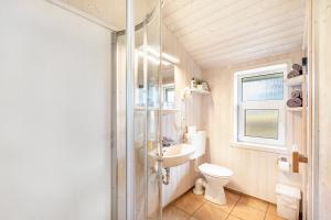 a bathroom with a toilet and a sink at Skipper-Lodge Ost in Kosel +17 photos