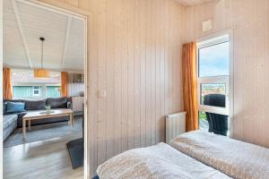 a bedroom with a bed and a living room at Skipper-Lodge Ost in Kosel