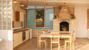 a kitchen with a table and a brick fireplace at Dimora Home Sweet Home with Private Pool in Putignano