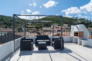 a balcony with chairs and a view of a mountain at Casa Da Quelha in Armamar