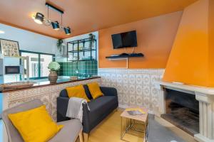 a living room with a couch and a fireplace at Casa Da Quelha in Armamar