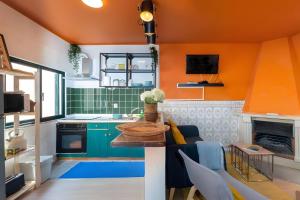 a kitchen with orange walls and a table in a room at Casa Da Quelha in Armamar