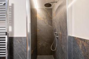 a bathroom with a shower with a glass door at Valgrisa Mountain Lodges 3 in Valgrisenche +21 photos