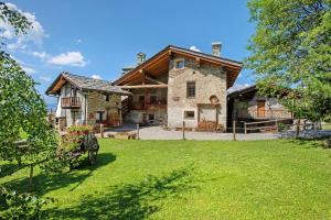 a large stone house with a grass yard at Maison Peroulaz Charvensod in Charvensod