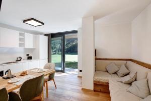 a living room with a couch and a table at Valgrisa Mountain Lodges 3 in Valgrisenche
