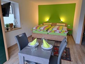 a small room with a bed and a table and chairs at Ferienwohnung Morgensonne in Nagel