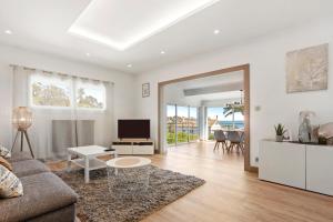 a living room with a couch and a table at Villa Palmier avec piscine in Roquebrune-sur-Argens
