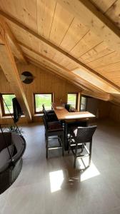 a room with a wooden ceiling with a table and chairs at Truma Swing Castelfondo in Castelfondo