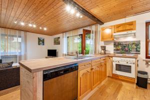 a kitchen with wooden cabinets and a counter top at Ferienwohnung Raab in Zandt +16 photos