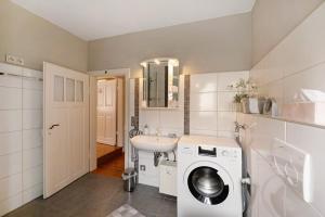 a bathroom with a washing machine and a sink at Haus Gertrud in Monzelfeld +17 photos