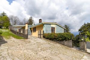 a house with a fence in front of it at Al Castagneto Foresteria Lombarda in Montevecchia