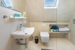 a bathroom with a sink and a toilet at Behagliche Wohnung Hüfingen in Hüfingen +13 photos