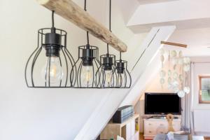 a group of glass lights hanging from the stairs at Behagliche Wohnung Hüfingen in Hüfingen