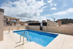 a swimming pool on the roof of a building at Suite Jinetes in Málaga