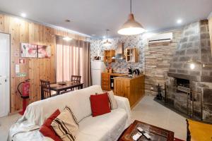 a living room with a couch and a fireplace at Cantinho do Sossego in Várzea
