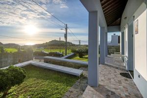 a porch of a house with a view of a street at Cantinho do Sossego in Várzea