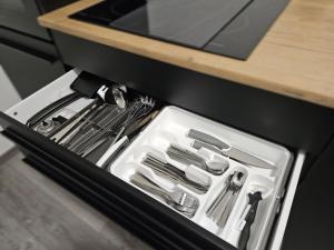a drawer in a kitchen with utensils in it at Relax in der Röntgenstadt in Remscheid