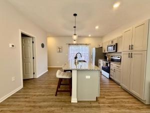 a kitchen with a sink and a counter top at The Meadowlark at Coventry Rows in Omaha