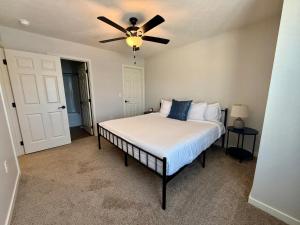 a bedroom with a bed with a ceiling fan at The Meadowlark at Coventry Rows in Omaha