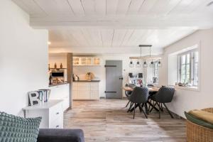 a kitchen and living room with a table and chairs at Luis- Hus in Dagebüll