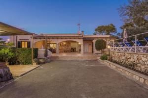 an estate with a stone wall and a driveway at Sa Caseta Rustic Villa in Cala d´Or
