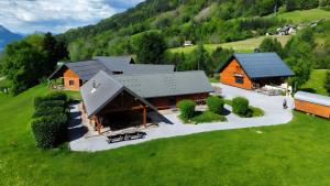 an overhead view of a cabin in a green field at Hostel du Val de Tamié in Faverges