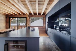 a kitchen with blue cabinets and a large island at Chalet G2 in Les Angles