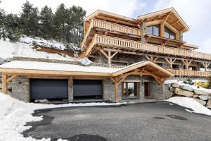 a large wooden house in the snow at Chalet G2 in Les Angles