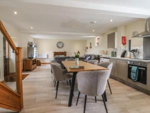 a kitchen and living room with a table and chairs at Mulberry Manor in Hull