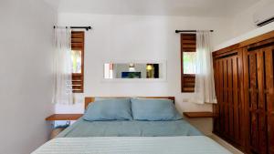 a bedroom with a bed and a mirror at Casa Lowen Villa with Private Pool in Las Terrenas +46 photos