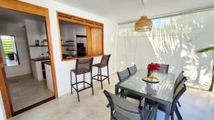 a dining room and kitchen with a table and chairs at Casa Lowen Villa with Private Pool in Las Terrenas
