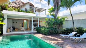 a villa with a swimming pool in front of a house at Casa Lowen Villa with Private Pool in Las Terrenas