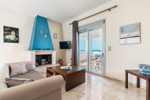 a living room with a couch and a fireplace at Blue Pearl Apolakkia 2 in Apolakkiá