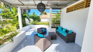 an outdoor seating area on a balcony with a view of the ocean at Casa Lowen Villa with Private Pool in Las Terrenas