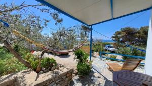 a porch with a hammock in a house at Syros Mandala Studios in Megas Gialos - Nites