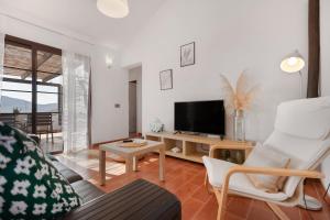 a living room with a tv and a couch and a table at Casa Tagaide in Tuineje